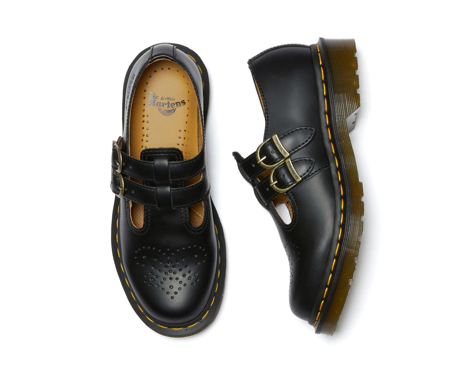 A black leather Dr. Martens mary jane shoe with brass buckles.