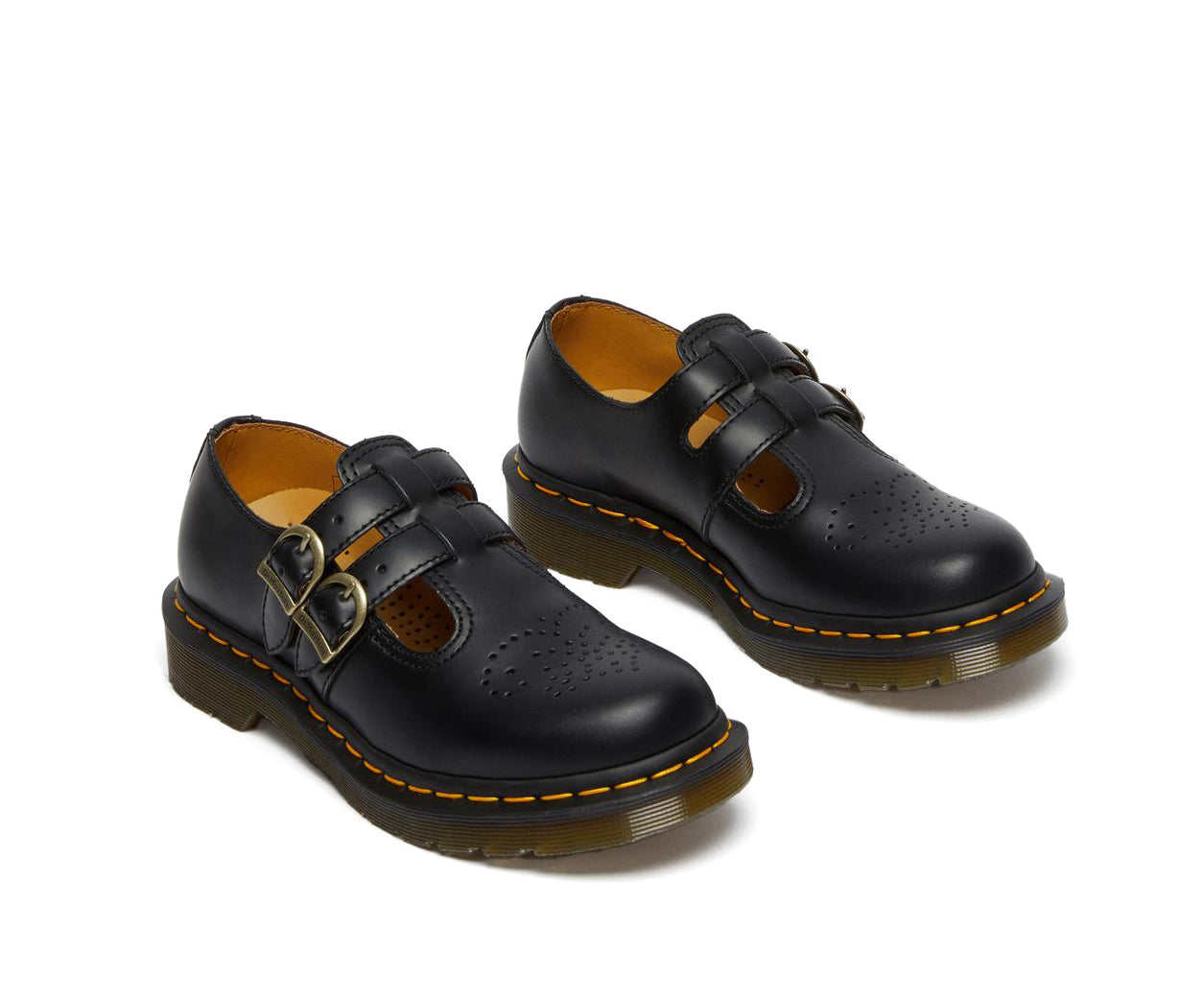 A black leather Dr. Martens mary jane shoe with brass buckles.