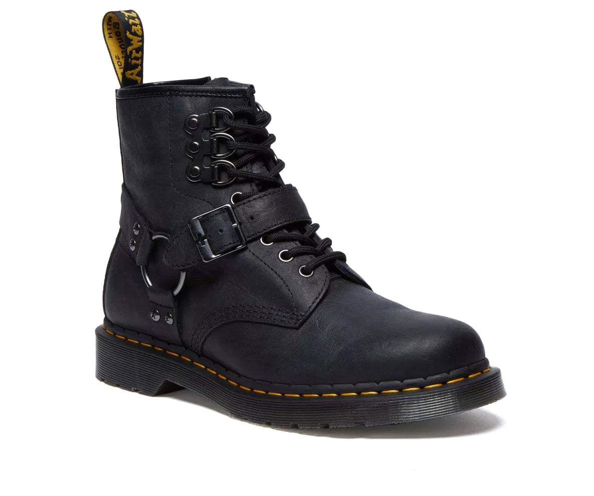 A black leather boot from Dr. Martens with additional straps and buckles.