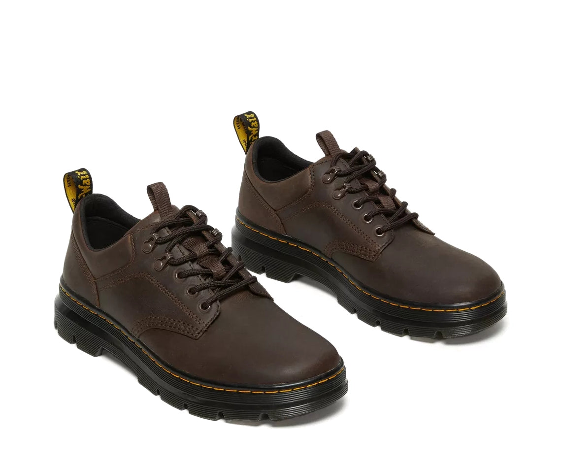 A dark brown leather shoe from Dr. Martens.