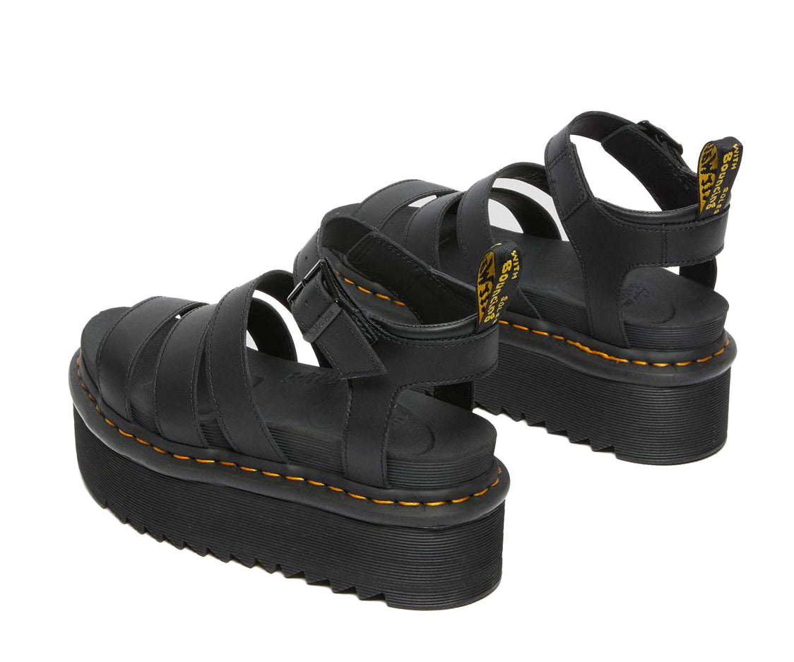 A black platform 3-strap sandal with ankle buckle from Dr. Martens.