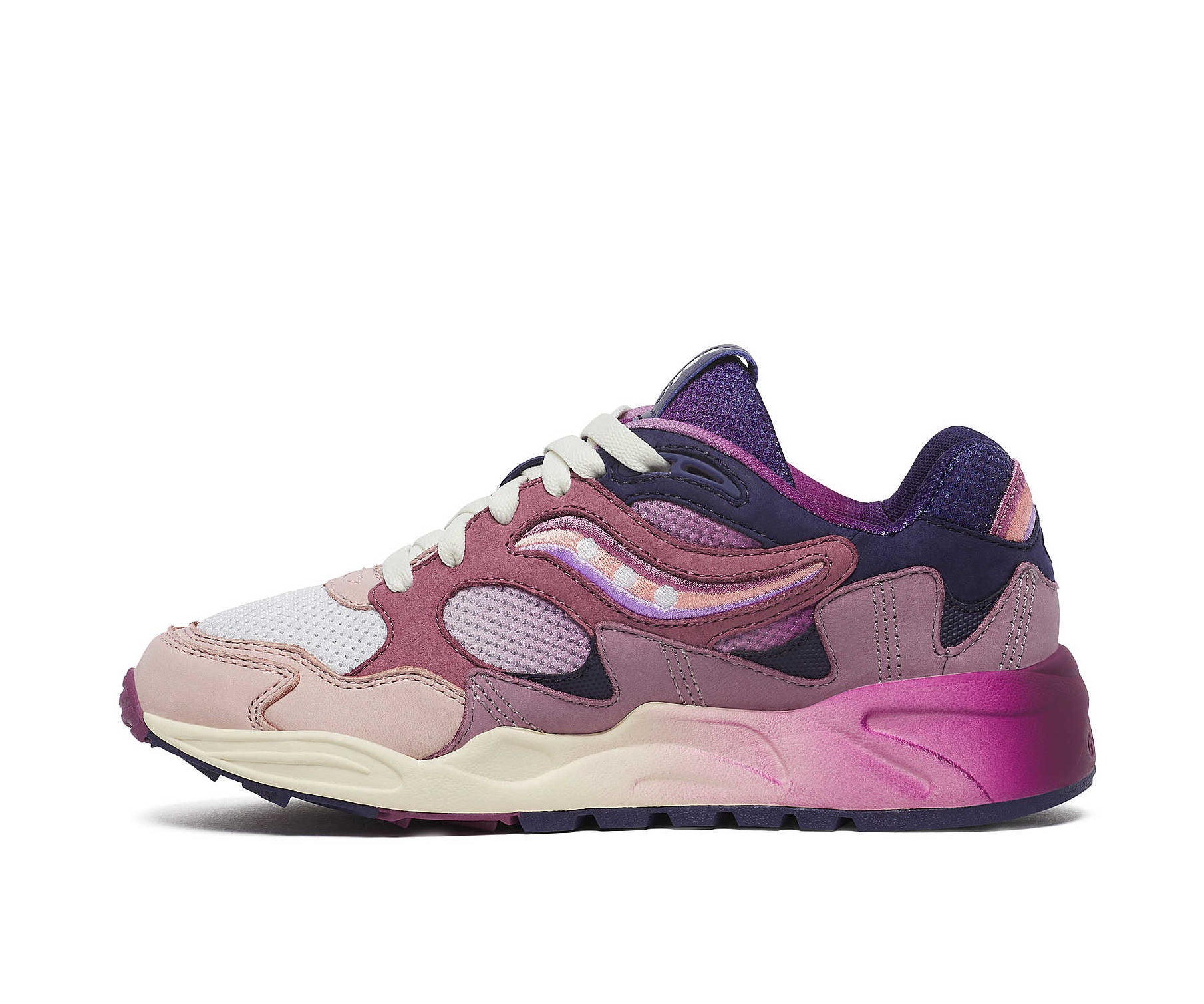 A purple sneaker from Saucony with dark blue accents and a magenta to white gradient.