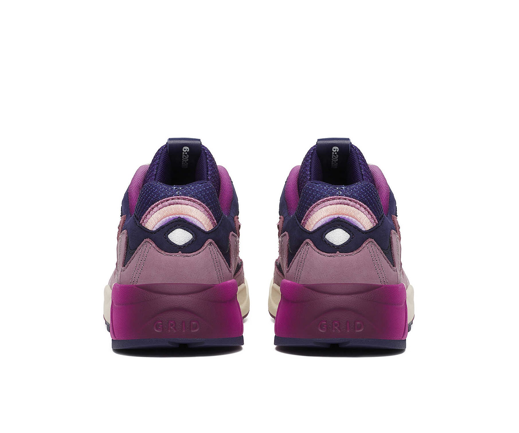 A purple sneaker from Saucony with dark blue accents and a magenta to white gradient.